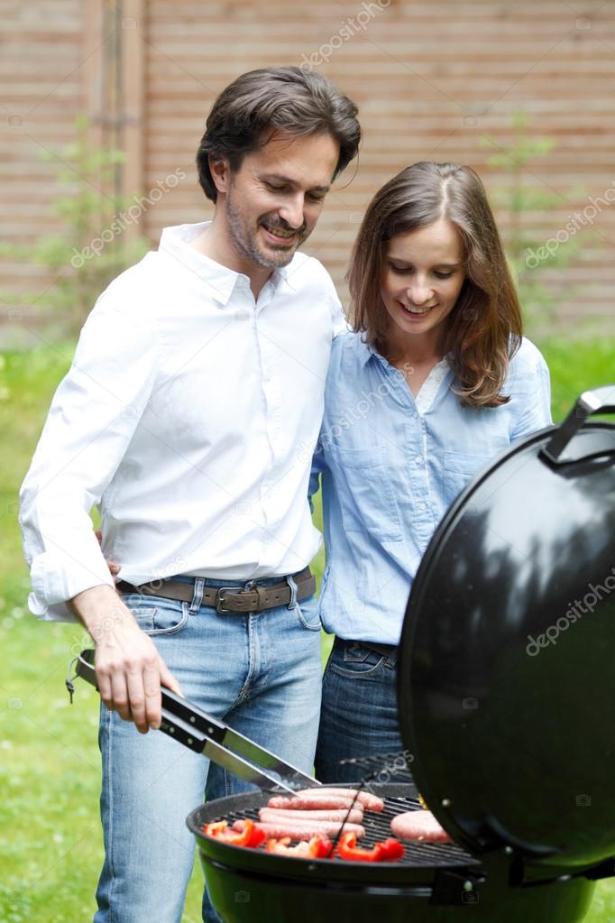 couple cooking outdoors