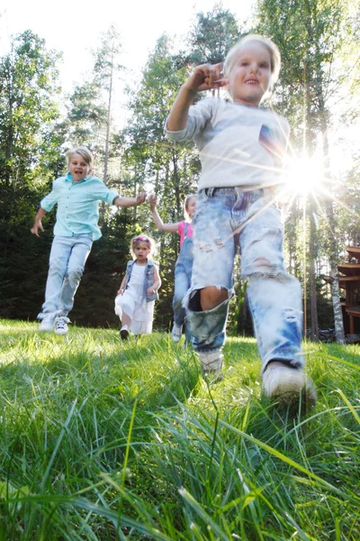 Kids running in park Stock Image