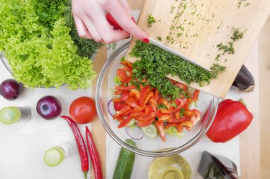 Kadınların elleri kıyılmış yeşillikleri.