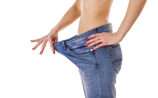 Woman in big jeans. — Stock Photo, Image