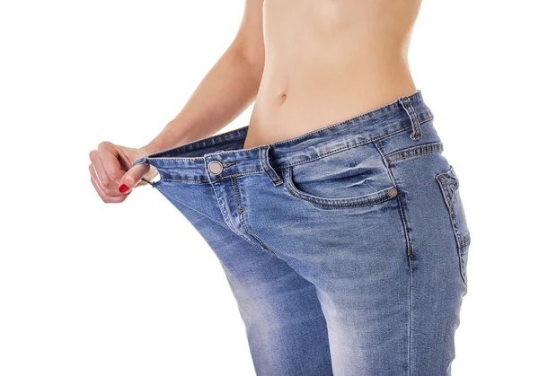 Woman in big jeans. — Stock Photo, Image