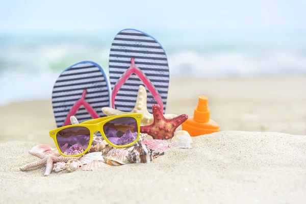 Flip-flops och skal på stranden. — Stockfoto