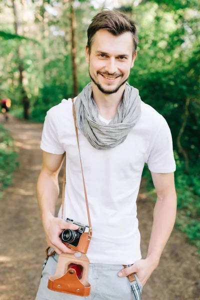 Photographer on a forest walk with a camera — Stock Photo, Image