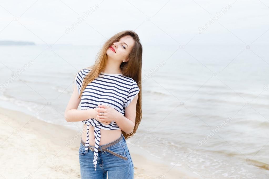 Pretty Stylish Brunette Girl In Blue Jeans And White Blouse Posing In  Summer Park Background Stock Photo, Picture and Royalty Free Image. Image  130041997.