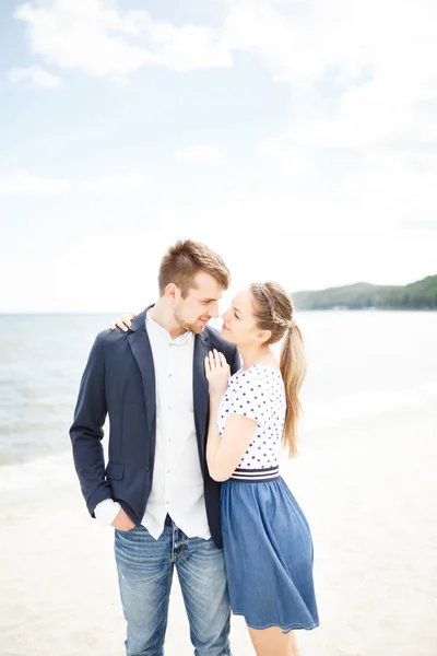 European couple relaxing on the sea beach hugging each other — Stock Photo, Image