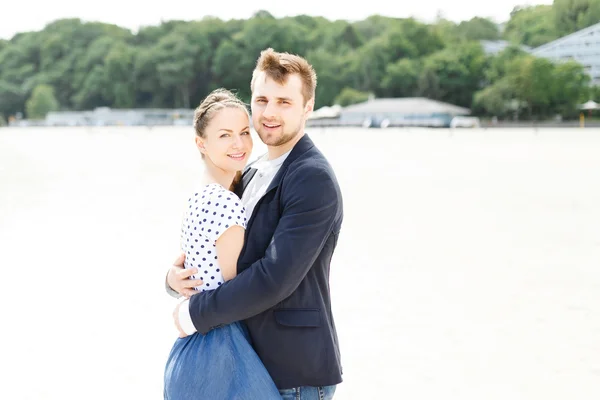 European couple relaxing on the sea beach hugging each other — Stock Photo, Image