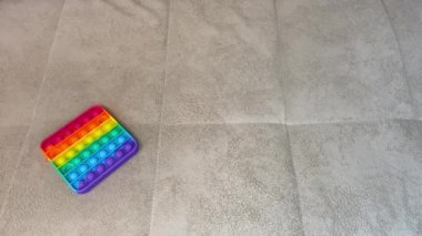 Hand picks up a popular pop it toy