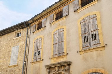 Shuttered windows on an old apartment  building, Lourmarin, Vaucluse, Provence-Alpes-Cote d'Azur, France