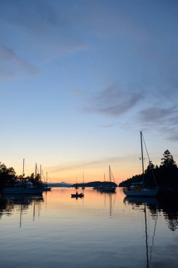 Boats at anchor in Princess Bay at sunset, Wallace Island, Gulf Islands, British Columbia, Canada