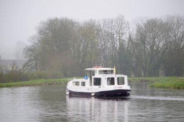 Canal boat in the mist on the Nivernais Canal, Burgundy, France