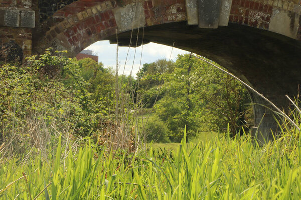 Solid brickwork of a bridge across a stream