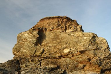 Güneş Carlyon Körfezi, St Austell, Cornwall, İngiltere 'de batıyor. Denizde tek bir kaya sütuna karşı. Muhteşem sarı bir renk yaratıyor.