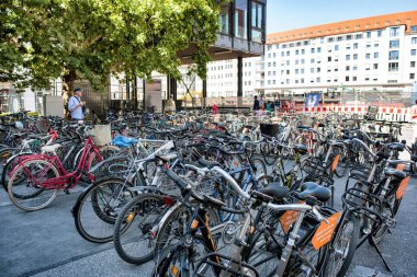 Munich, Germany - September 15, 2018: a great number of parking bicycles in a street on sunny day in a city.