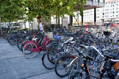 Munich, Germany - September 15, 2018: a great number of parking bicycles in a street on sunny day in a city.