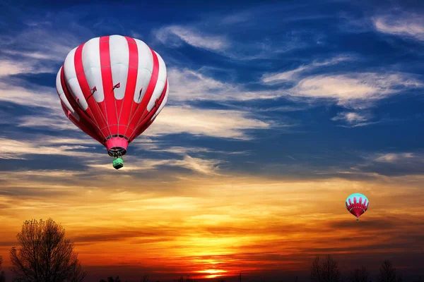 Parlak Turuncu Günbatımının Arka Planında Kırmızı Beyaz Hava Balonları — Stok fotoğraf