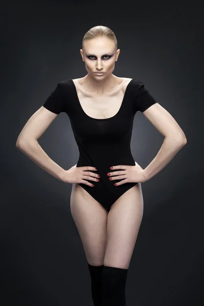 Woman in a one-piece black swimsuit — Stock Photo, Image