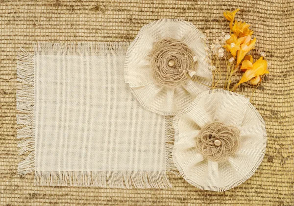 Flower rose made of fabric on burlap background with space for text — Stock Photo, Image