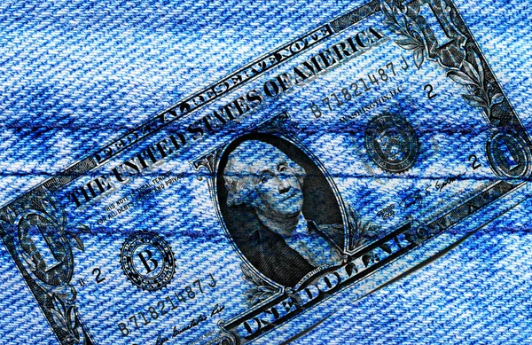 Dollar print on blue jeans fabric background — Stockfoto