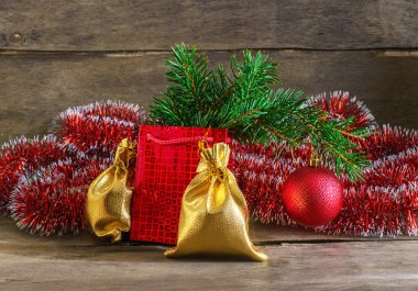 Gifts, Christmas tree, ball, tinsel on the wooden background