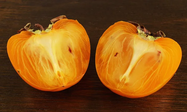 Ripe orange persimmon on the wooden background — Stock Photo, Image