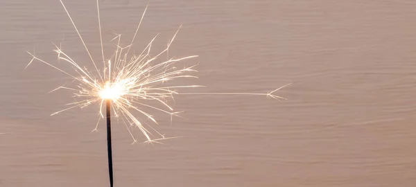 Sparklers on a Set Sail Champagne Colour background.