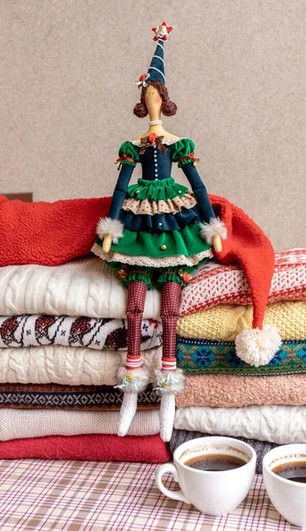 A Lot of Sweaters and Pullovers Different Colours folded in two Piles and Hand made Doll Toy. — Stock Image Lot Sweaters Pullovers Different Colours Folded Two Piles Hand Made Stock Image