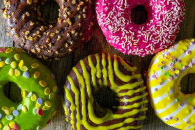 Ahşap zemin üzerinde farklı yuvarlak pastalar kümesi, üst görünüm