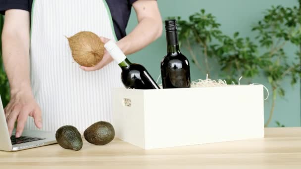 Deliver Apron Puts Coconuts Avocado White Box Two Wine Bottles — Stock Video