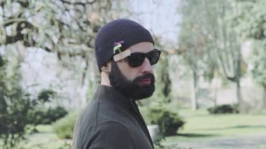 Adam ceketi açar ve vücudunda bahar çiçekleri ve tıbbi yapıştırıcı gösterir..
