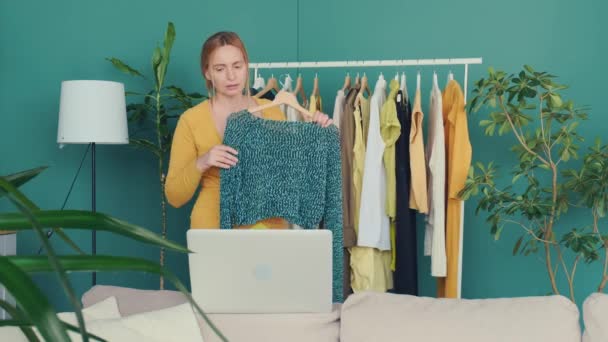 Middle Aged Blond Woman Communicates Online Laptop Shows Clothes Shelf — Stock Video