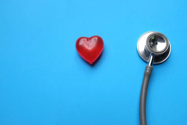 stethoscope with  red hearts on a blue background, diagnosis of heart disease