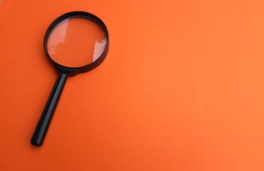 copy space magnifying glass isolate on orange background clipart