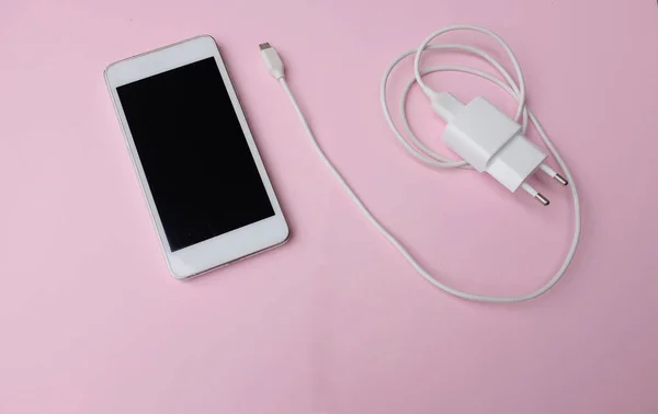 Top View Flat Lay White Smartphone Plug Charger Adapter Pink — Stockfoto