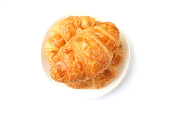 新鲜的新鲜烤羊角面包在一个白色圆形陶瓷盘上 早餐概念 — 图库照片