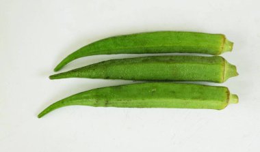 young raw okra, ladys finger, gombo, gumbo, bendee, quimbamto (hisbicus esculentus l.) vegetables .flat lay