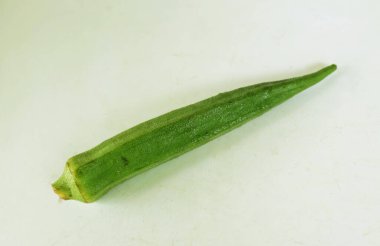 young raw okra, ladys finger, gombo, gumbo, bendee, quimbamto (hisbicus esculentus l.) vegetables .flat lay