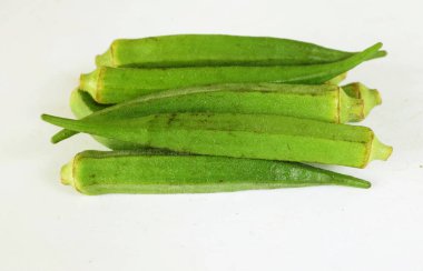 young raw okra, ladys finger, gombo, gumbo, bendee, quimbamto (hisbicus esculentus l.) vegetables .flat lay
