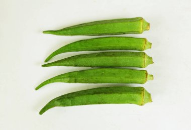 young raw okra, ladys finger, gombo, gumbo, bendee, quimbamto (hisbicus esculentus l.) vegetables .flat lay