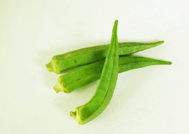 young raw okra, ladys finger, gombo, gumbo, bendee, quimbamto (hisbicus esculentus l.) vegetables .flat lay