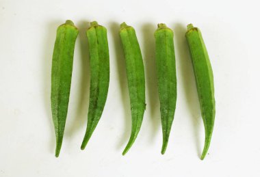 young raw okra, ladys finger, gombo, gumbo, bendee, quimbamto (hisbicus esculentus l.) vegetables .flat lay