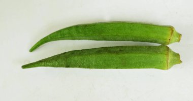 young raw okra, ladys finger, gombo, gumbo, bendee, quimbamto (hisbicus esculentus l.) vegetables .flat lay