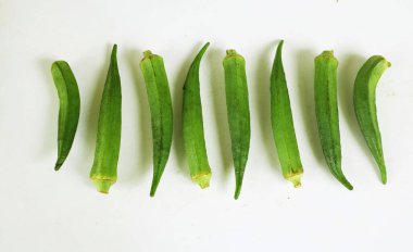 young raw okra, ladys finger, gombo, gumbo, bendee, quimbamto (hisbicus esculentus l.) vegetables .flat lay