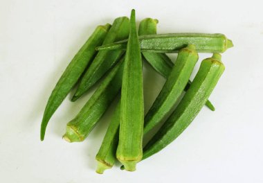 young raw okra, ladys finger, gombo, gumbo, bendee, quimbamto (hisbicus esculentus l.) vegetables .flat lay
