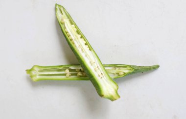 young raw okra, ladys finger, gombo, gumbo, bendee, quimbamto (hisbicus esculentus l.) vegetables .flat lay