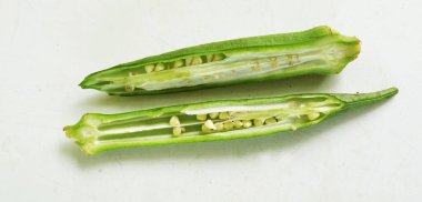 young raw okra, ladys finger, gombo, gumbo, bendee, quimbamto (hisbicus esculentus l.) vegetables .flat lay