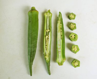 young raw okra, ladys finger, gombo, gumbo, bendee, quimbamto (hisbicus esculentus l.) vegetables .flat lay