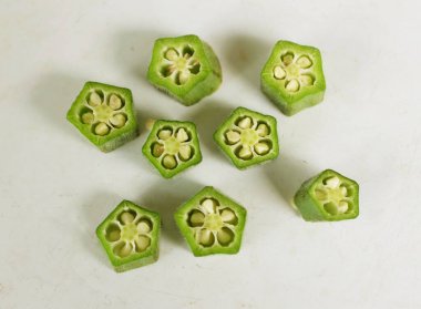 young raw okra, ladys finger, gombo, gumbo, bendee, quimbamto (hisbicus esculentus l.) vegetables .flat lay