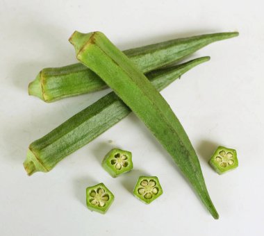 young raw okra, ladys finger, gombo, gumbo, bendee, quimbamto (hisbicus esculentus l.) vegetables .flat lay