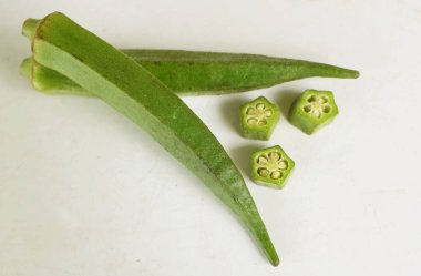 young raw okra, ladys finger, gombo, gumbo, bendee, quimbamto (hisbicus esculentus l.) vegetables .flat lay