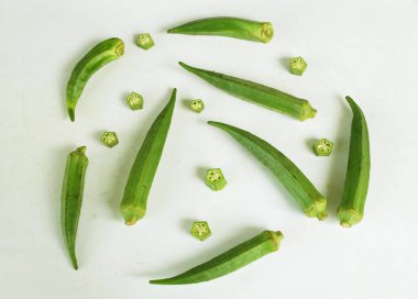 young raw okra, ladys finger, gombo, gumbo, bendee, quimbamto (hisbicus esculentus l.) vegetables .flat lay